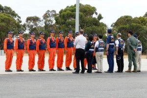 Members of the Japan Coast Guard are greeted by officials at the Pearce Airforce base in Australia 