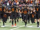 Gilmer players (from left) Blake Lynch, Chris Boyd, Chase Tate and McLane Carter carry the jersey of the late Desmond Pollard (8) and Gladewater's Nikalas Wisinger (68) out to the coin toss before their Class 4A Division II state championship game against West Orange-Stark on Friday at AT&T Stadium in Arlington. (Jeff Stapleton, ETSN.fm)