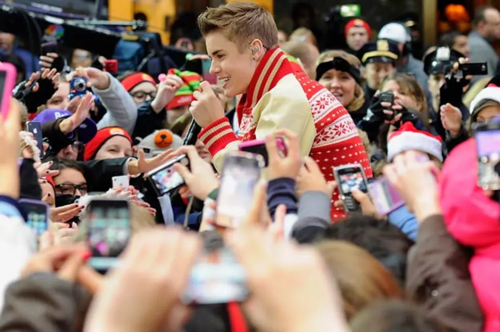 Justin Bieber Mobbed at Airport, Collides With Photographer