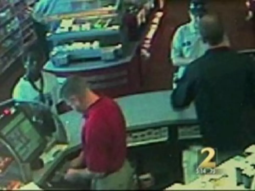 Dumbest Criminal Ever Robs Store With Cop Standing Right Behind Him [VIDEO]